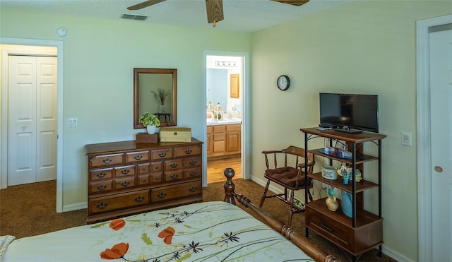 bedroom with baseboards, ensuite bath, visible vents, ceiling fan, and carpet
