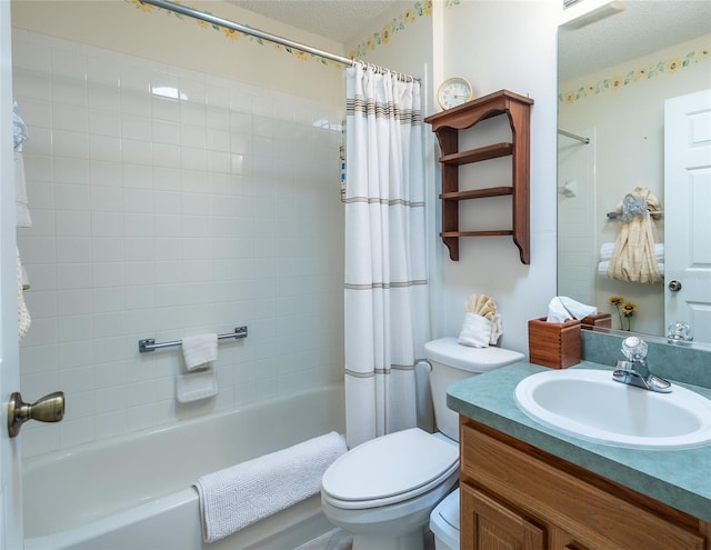 bathroom with toilet, shower / tub combo, vanity, and a textured ceiling