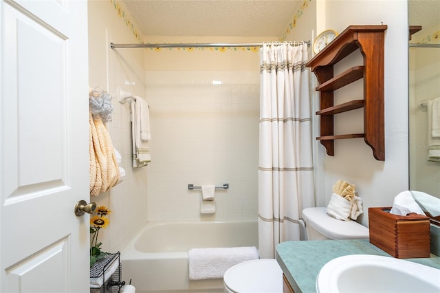 full bathroom featuring shower / tub combo with curtain, vanity, a textured ceiling, and toilet