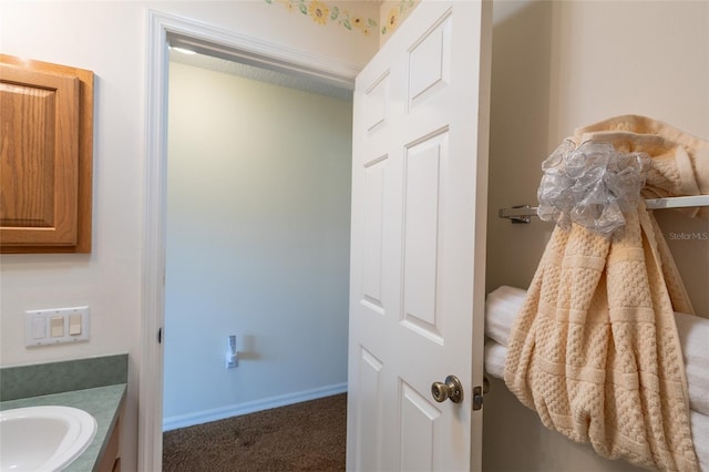 bathroom with baseboards and vanity