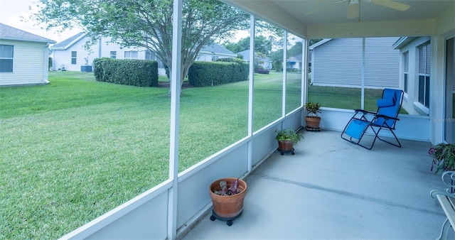 unfurnished sunroom featuring ceiling fan
