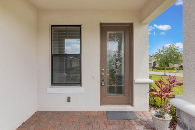 2129 Palm Tree Dr, Poinciana, FL 34759 - doorway to property with stucco siding