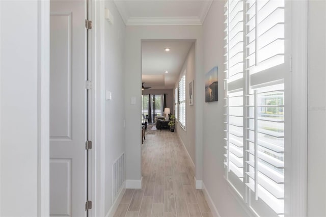 2129 Palm Tree Dr, Poinciana, FL 34759 - corridor featuring light wood finished floors, baseboards, visible vents, and crown molding