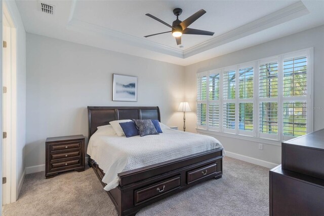 2129 Palm Tree Dr, Poinciana, FL 34759 - bedroom with a tray ceiling, visible vents, baseboards, light colored carpet, and crown molding