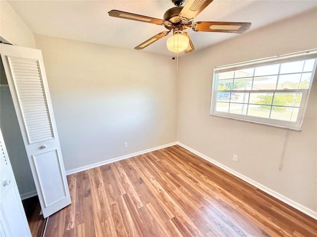 unfurnished bedroom featuring baseboards, light wood finished floors, and ceiling fan
