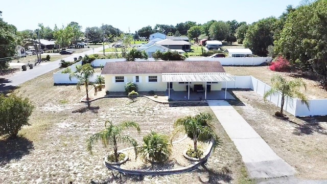 exterior space featuring concrete driveway, a patio, a fenced backyard, and stucco siding