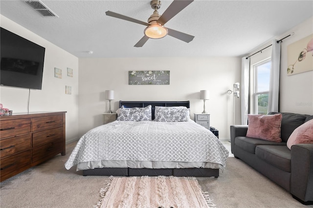 carpeted bedroom featuring visible vents and ceiling fan