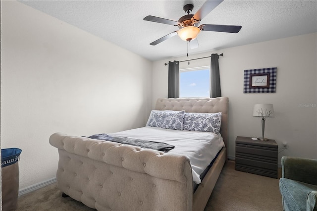 bedroom with a textured ceiling, carpet flooring, ceiling fan, and baseboards