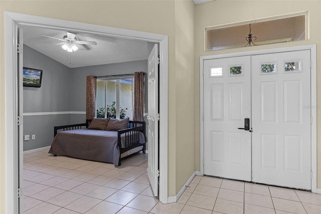 14 Clear Ct, Palm Coast, FL 32137 - entryway with light tile patterned floors, baseboards, a ceiling fan, and vaulted ceiling