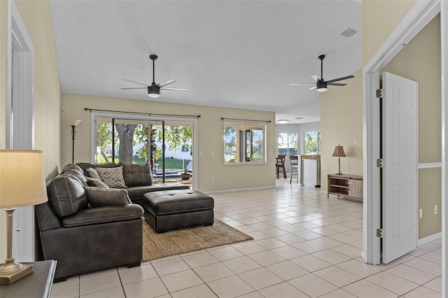 14 Clear Ct, Palm Coast, FL 32137 - living room with visible vents, baseboards, a ceiling fan, and light tile patterned flooring