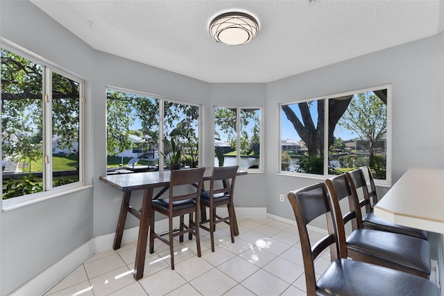 14 Clear Ct, Palm Coast, FL 32137 - dining room with a textured ceiling, baseboards, and tile patterned flooring