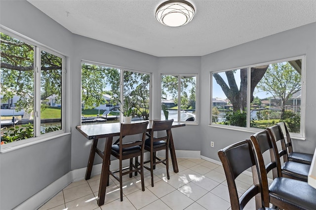 14 Clear Ct, Palm Coast, FL 32137 - dining area featuring a textured ceiling and a healthy amount of sunlight