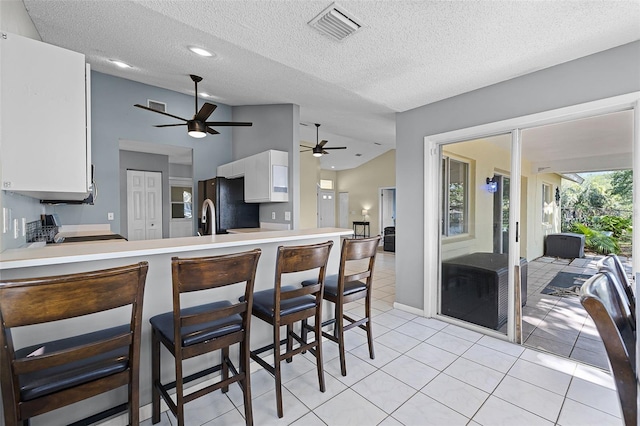 14 Clear Ct, Palm Coast, FL 32137 - kitchen with ceiling fan, freestanding refrigerator, white cabinets, visible vents, and light countertops