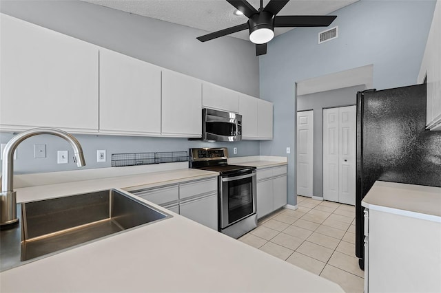 14 Clear Ct, Palm Coast, FL 32137 - kitchen featuring a ceiling fan, white cabinets, visible vents, appliances with stainless steel finishes, and a sink