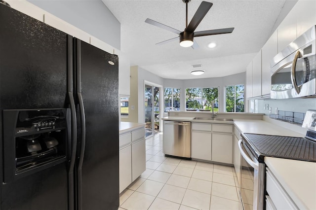 14 Clear Ct, Palm Coast, FL 32137 - kitchen featuring a sink, a textured ceiling, a ceiling fan, and stainless steel appliances