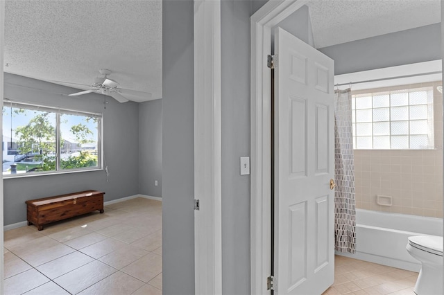 14 Clear Ct, Palm Coast, FL 32137 - bathroom featuring toilet, ceiling fan, shower / tub combo with curtain, a textured ceiling, and tile patterned floors