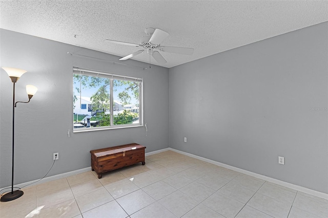 14 Clear Ct, Palm Coast, FL 32137 - empty room with a textured ceiling, light tile patterned flooring, and a ceiling fan