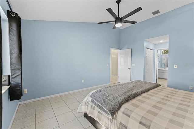 14 Clear Ct, Palm Coast, FL 32137 - bedroom with connected bathroom, vaulted ceiling, visible vents, light tile patterned flooring, and baseboards