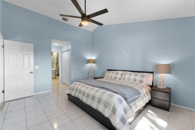 14 Clear Ct, Palm Coast, FL 32137 - bedroom with baseboards, ensuite bathroom, light tile patterned flooring, visible vents, and lofted ceiling