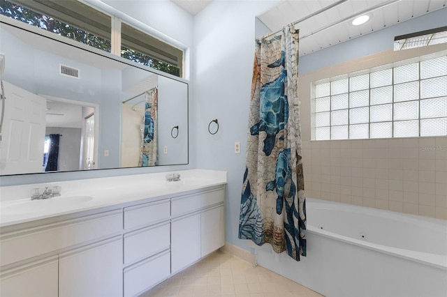14 Clear Ct, Palm Coast, FL 32137 - bathroom featuring visible vents, baseboards, a sink, double vanity, and tile patterned flooring