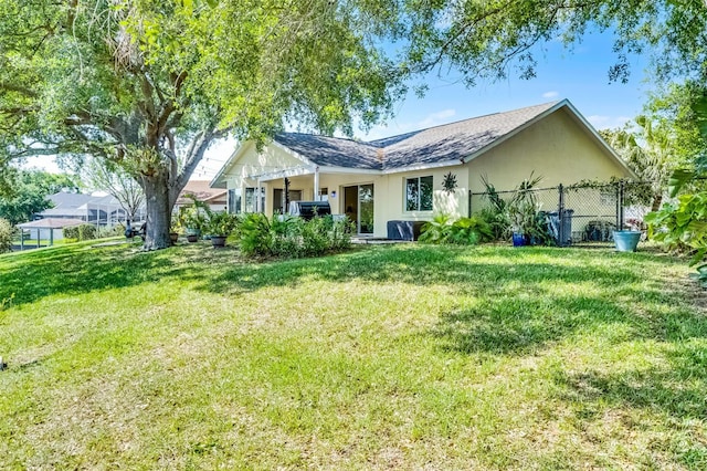 14 Clear Ct, Palm Coast, FL 32137 - back of house featuring stucco siding, fence, and a lawn