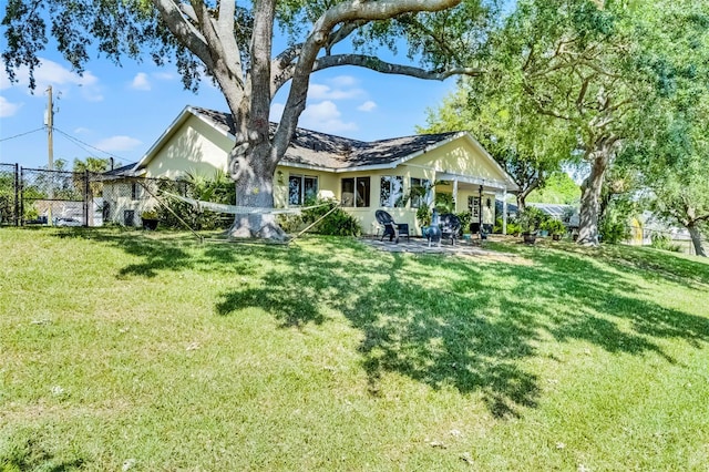 14 Clear Ct, Palm Coast, FL 32137 - rear view of house with a patio area, fence, and a lawn