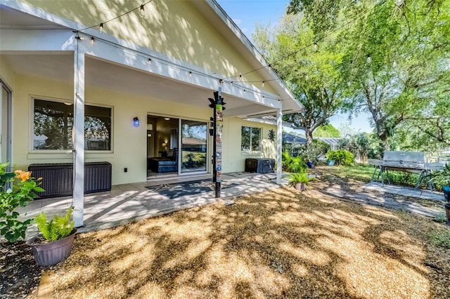14 Clear Ct, Palm Coast, FL 32137 - back of property with a patio area and stucco siding