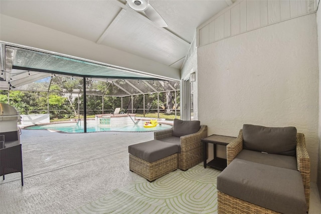 outdoor pool with glass enclosure and a patio area