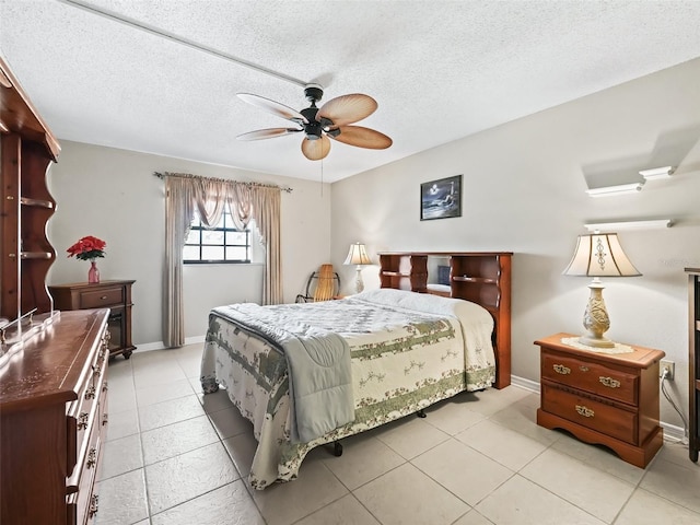 bedroom with baseboards, light tile patterned floors, and ceiling fan