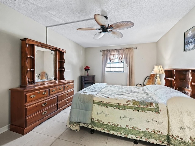 bedroom with light tile patterned floors, a textured ceiling, and a ceiling fan