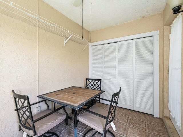 dining space featuring a textured wall