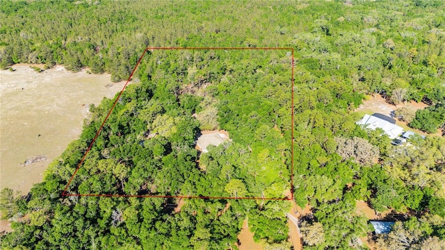 bird's eye view featuring a wooded view