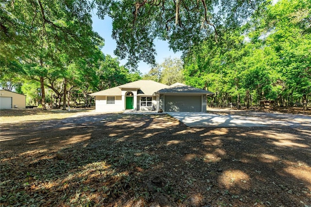 view of front of house with concrete driveway and an attached garage