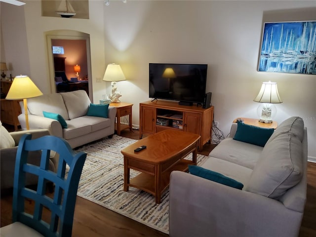 living room featuring wood finished floors and baseboards