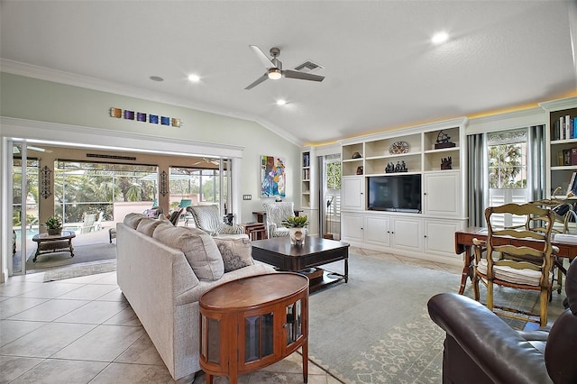 living area with vaulted ceiling, a ceiling fan, crown molding, light tile patterned floors, and visible vents