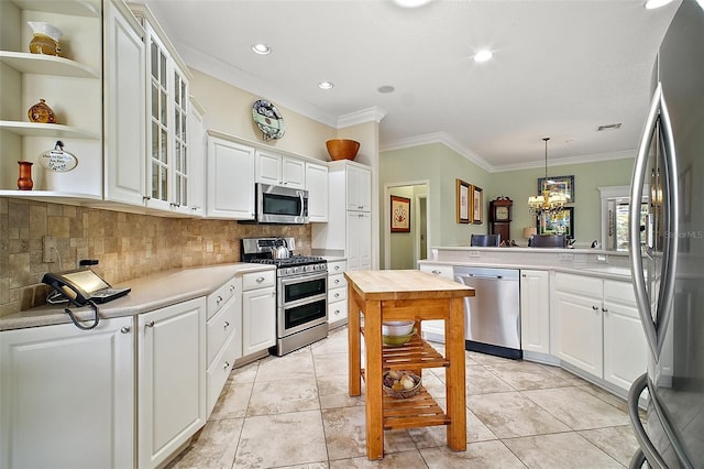kitchen with crown molding, tasteful backsplash, glass insert cabinets, stainless steel appliances, and light countertops