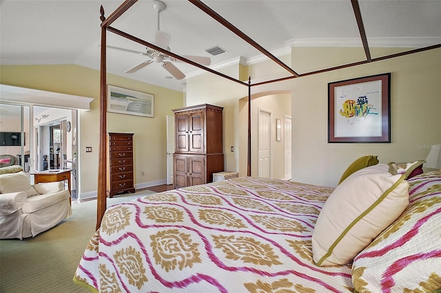 bedroom with arched walkways, lofted ceiling, visible vents, and crown molding