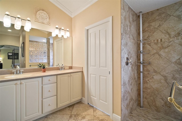 full bathroom with tiled shower, ornamental molding, and a sink