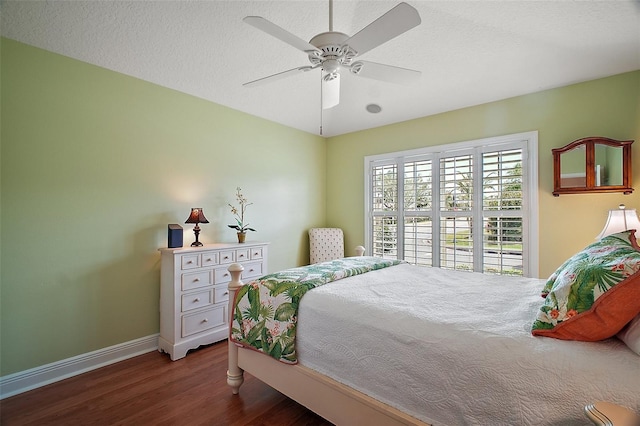 bedroom with baseboards, wood finished floors, and ceiling fan