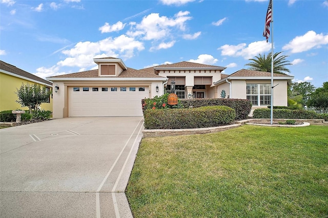 view of front facade featuring stucco siding, a garage, a front yard, and concrete driveway