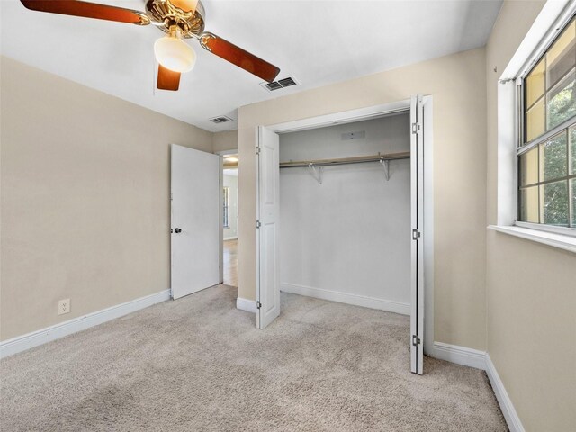 25519 Colmar Ave, Sorrento, FL 32776 - unfurnished bedroom with light carpet, a closet, ceiling fan, and baseboards