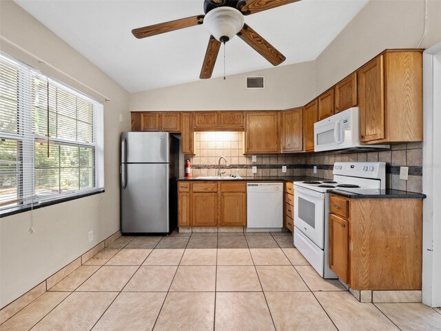 25519 Colmar Ave, Sorrento, FL 32776 - kitchen featuring white appliances, a sink, dark countertops, tasteful backsplash, and a ceiling fan