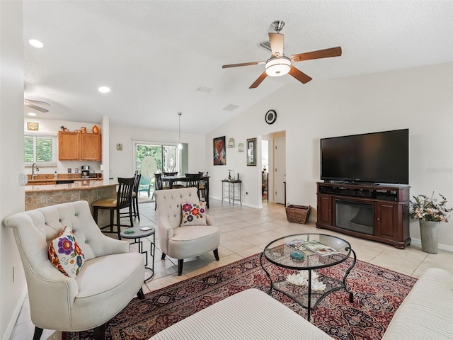 9621 SE 168th Maplesong Ln, The Villages, FL 32162 - living room with baseboards, ceiling fan, a wealth of natural light, and lofted ceiling