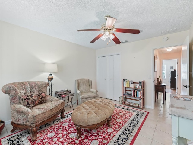 9621 SE 168th Maplesong Ln, The Villages, FL 32162 - sitting room with a textured ceiling, ceiling fan, and light tile patterned floors