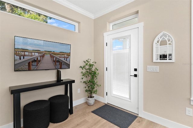 12129 Grand Oak Ln, Oxford, FL 34484 - foyer entrance with light wood finished floors, baseboards, and crown molding