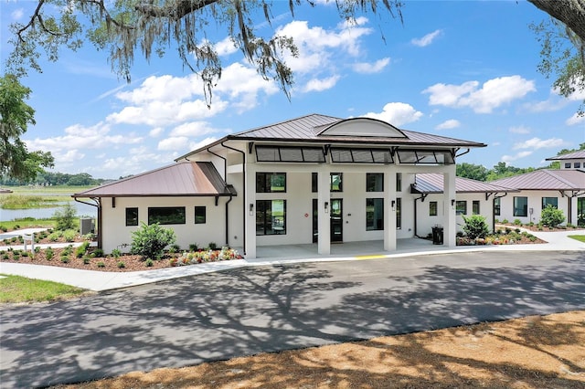 12129 Grand Oak Ln, Oxford, FL 34484 - view of building exterior with a water view
