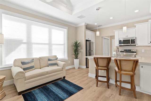 12129 Grand Oak Ln, Oxford, FL 34484 - living area featuring light wood-style flooring, visible vents, recessed lighting, and ornamental molding