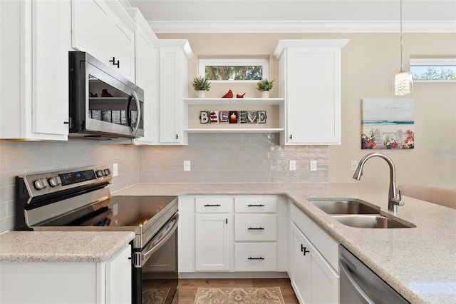 12129 Grand Oak Ln, Oxford, FL 34484 - kitchen with white cabinets, a sink, appliances with stainless steel finishes, open shelves, and ornamental molding