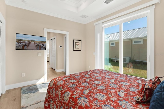 12129 Grand Oak Ln, Oxford, FL 34484 - bedroom featuring baseboards, crown molding, wood finished floors, and access to outside