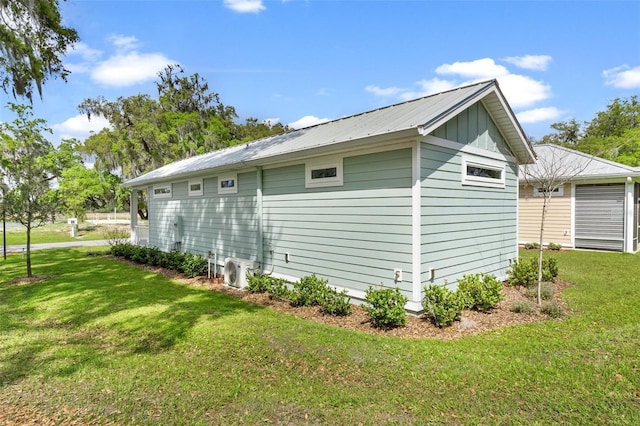 12129 Grand Oak Ln, Oxford, FL 34484 - view of side of property with a lawn, ac unit, and metal roof